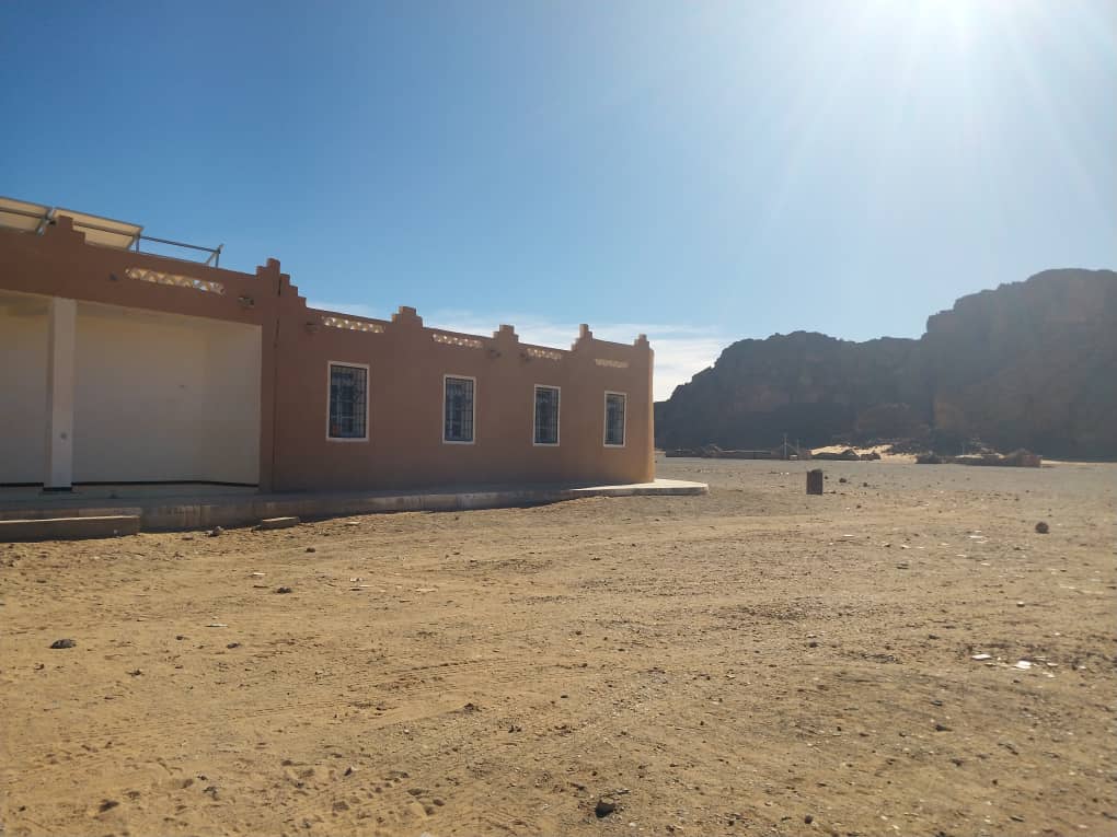 a building in the desert desert, building,mountains
