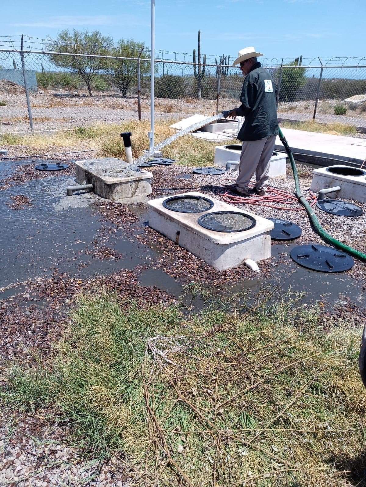 man,outdoors,hat,hose,water