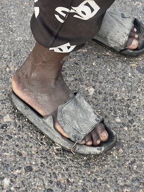 person wearing worn sandals